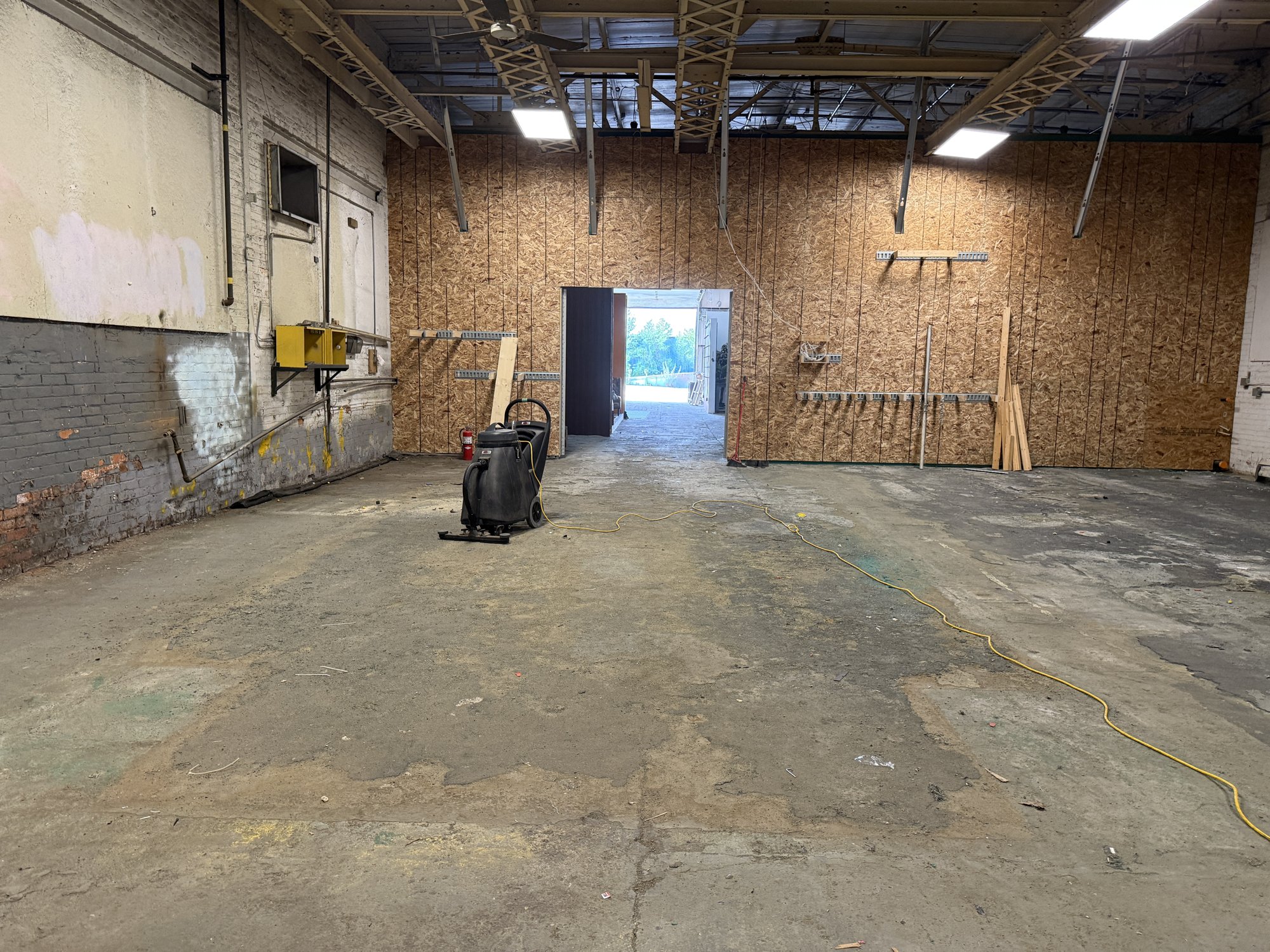 The build floor at 252 Stuart Street with the roll-up doors open to daylight