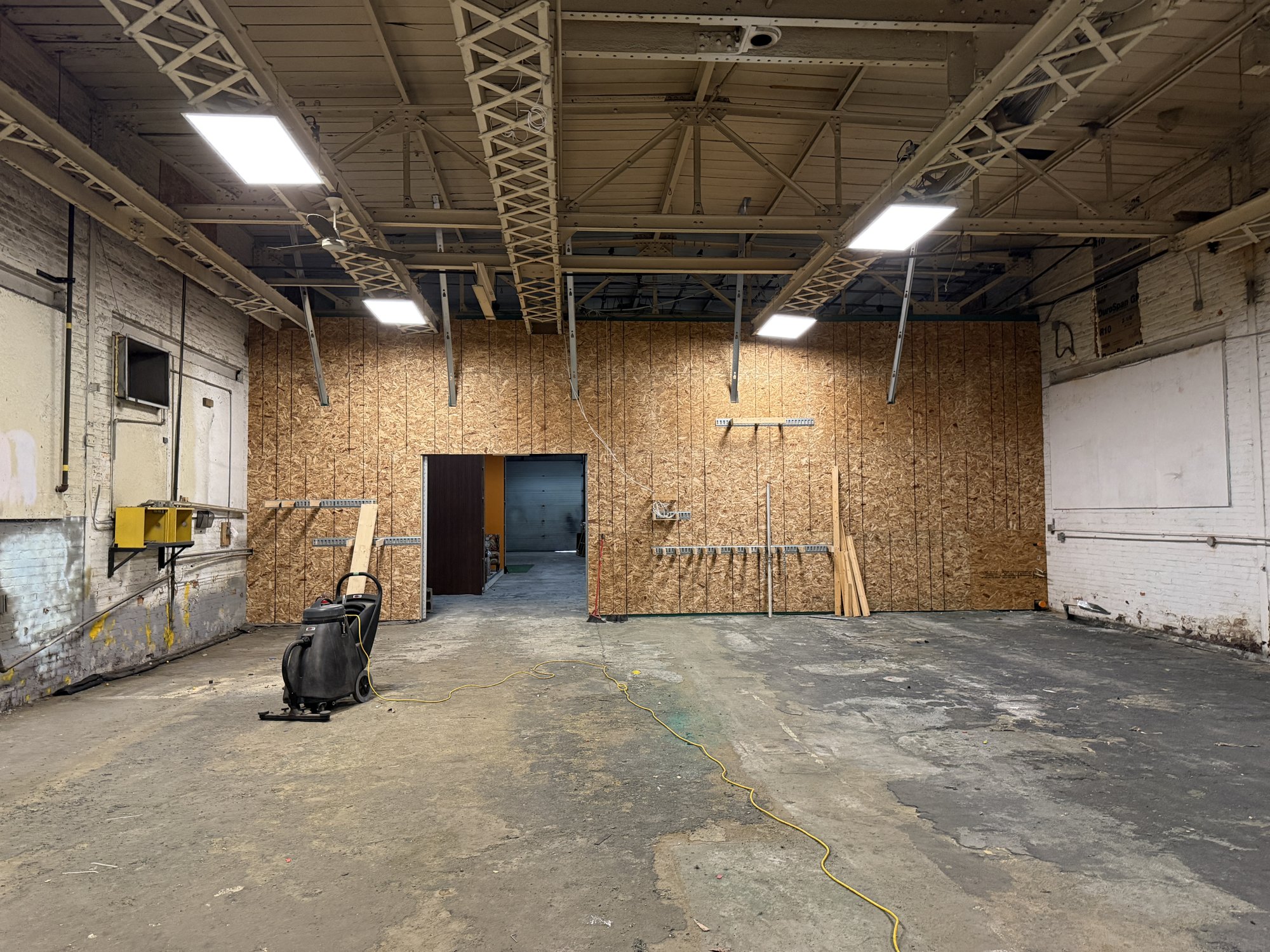 The back studio at 252 Stuart Street with its OSB wall and overhead lighting